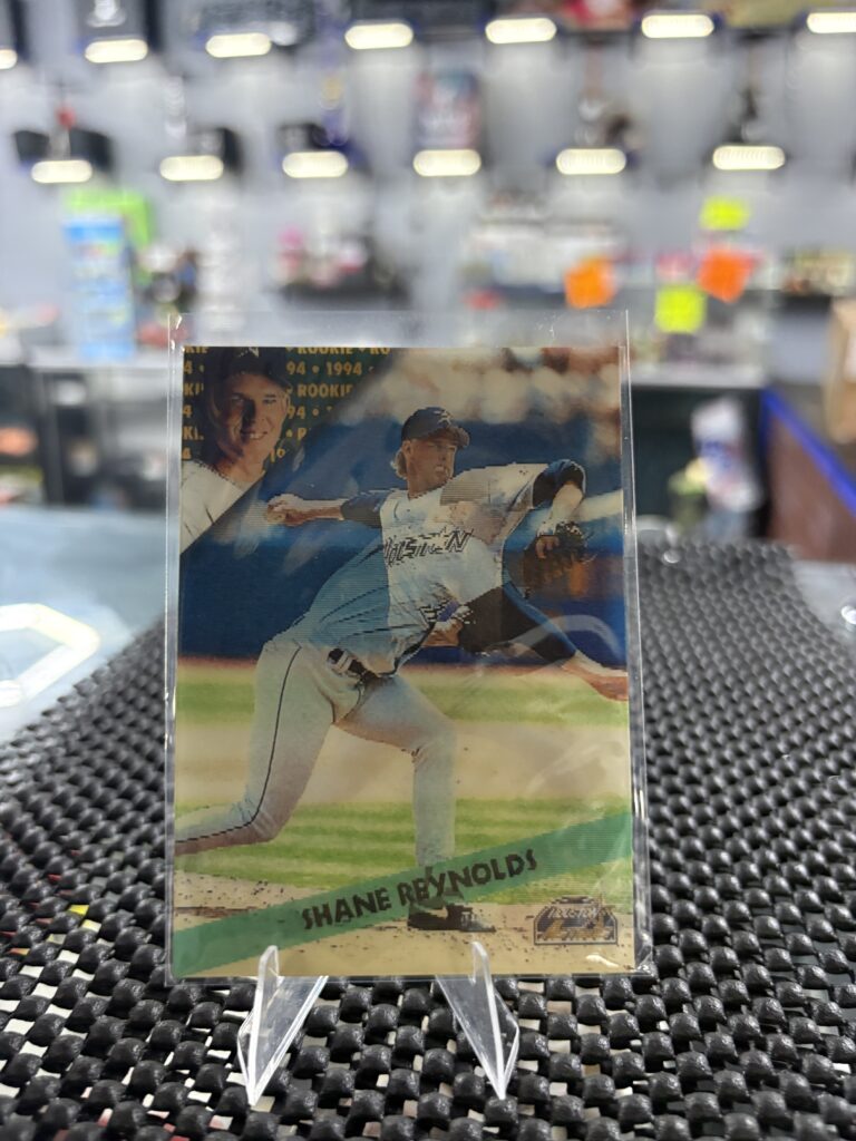 This 1994 rookie baseball card features pitcher Shane Reynolds in action, capturing a great baseball moment.