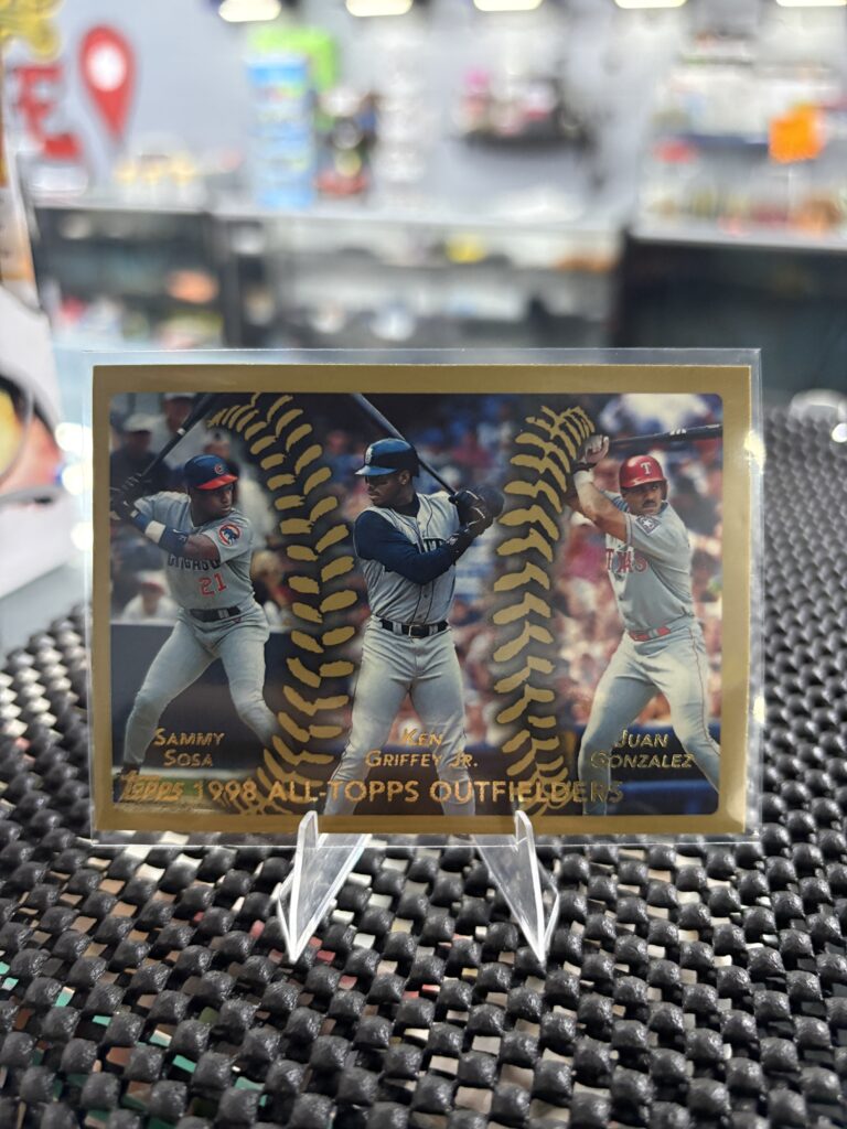 This classic 1998 Topps All-Topps Outfielders baseball card features legendary players Sammy Sosa, Ken Griffey Jr., and Juan Gonzalez, making it a prized item for sports collectors.