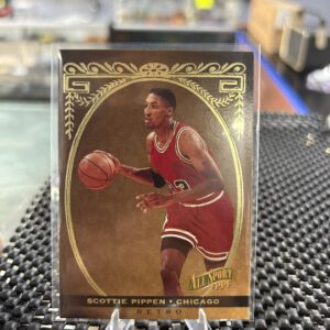This vintage Scottie Pippen basketball card features elegant gold foil detailing, making it a classic sports collectible.