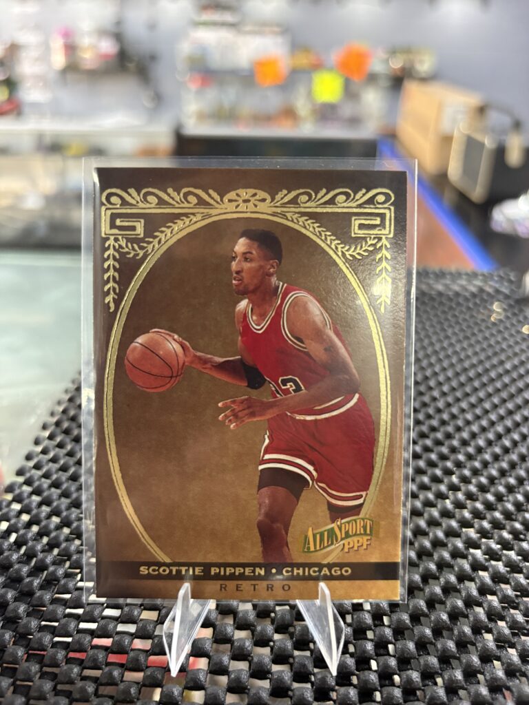 This vintage Scottie Pippen basketball card features elegant gold foil detailing, making it a classic sports collectible.