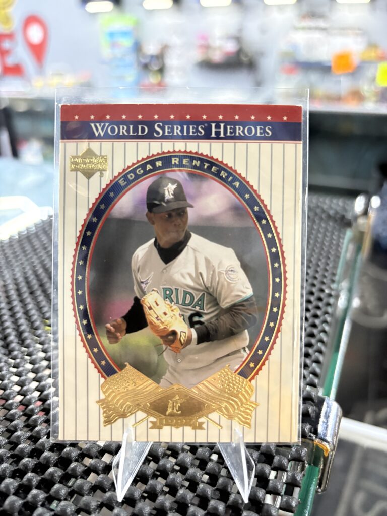 Florida Marlins Edgar Renteria Upper Deck World Series Heroes baseball trading card, golden action shot in protective sleeve, high quality vintage rare collectible in clear display case for serious baseball fans and investors today.