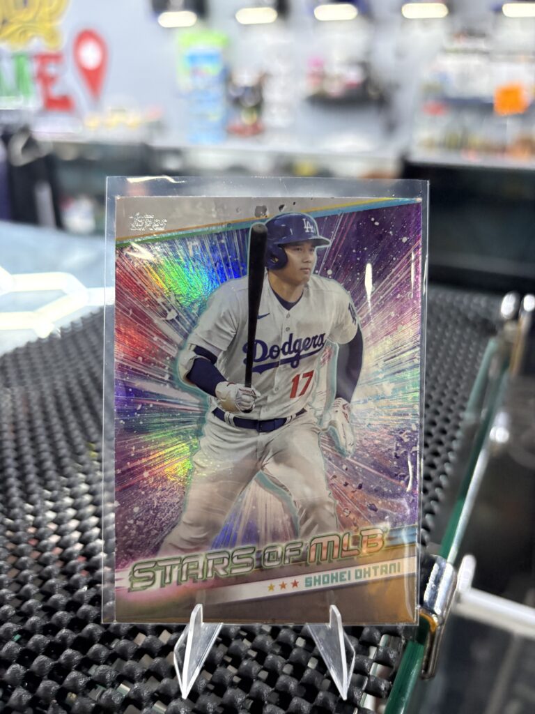 Los Angeles Dodgers Shohei Ohtani Topps Stars of MLB baseball trading card, holographic action shot in protective sleeve, high quality modern star player collectible in clear display case for serious baseball fans and investors today.