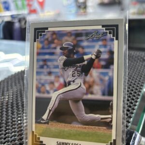 Chicago Cubs Sammy Sosa Leaf baseball trading card, powerful batting action shot in protective sleeve, high quality vintage rare collectible in clear display case for serious baseball fans and investors today.