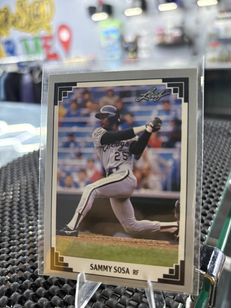 Chicago Cubs Sammy Sosa Leaf baseball trading card, powerful batting action shot in protective sleeve, high quality vintage rare collectible in clear display case for serious baseball fans and investors today.