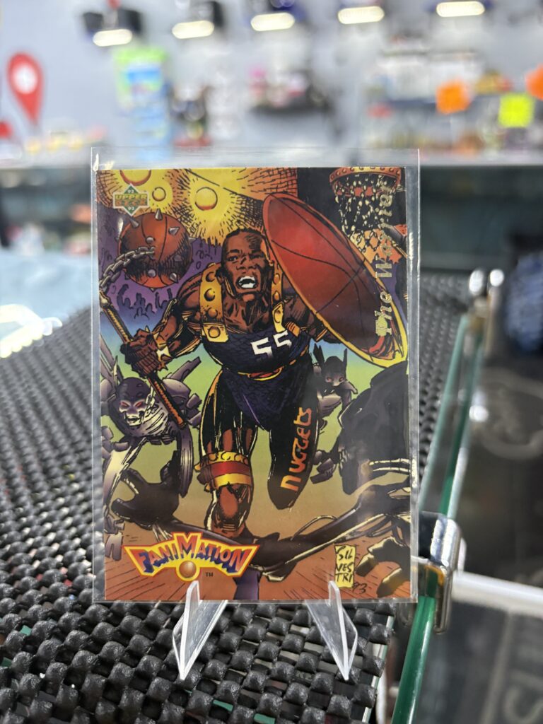 1993 Upper Deck Fanimation Dikembe Mutombo Nuggets basketball trading card, unique comic style artwork in protective sleeve, high quality vintage rare collectible in clear display case for serious basketball fans and investors today.