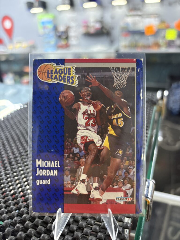 Michael Jordan 1991 Fleer League Leaders basketball trading card, action shot in protective sleeve, high quality vintage guard player collectible in clear display case for serious basketball fans and investors today.