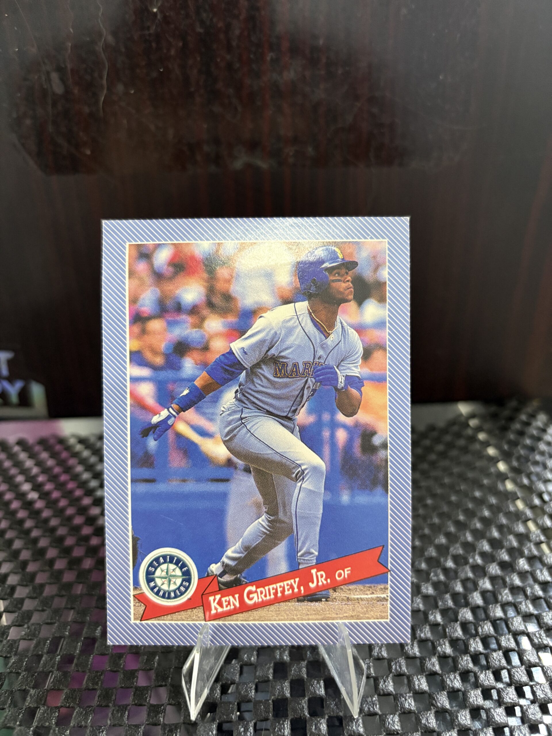 Seattle Mariners Ken Griffey Jr. vintage baseball trading card, base running action shot in protective sleeve, high quality rare collectible in clear display case for serious baseball fans and card investors today.