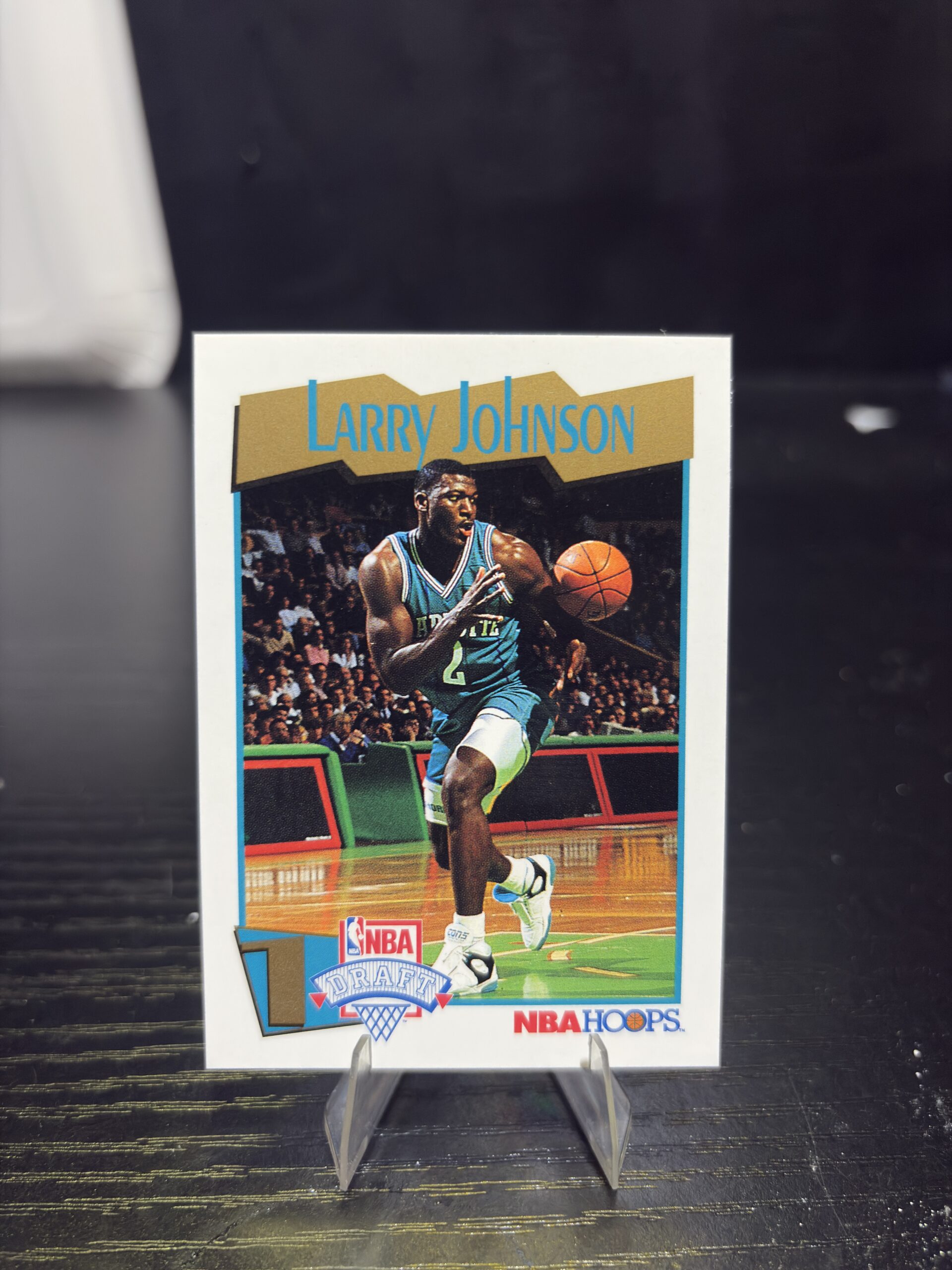 Charlotte Hornets Larry Johnson 1991 NBA Hoops Draft basketball trading card, action shot in protective sleeve, high quality vintage rare collectible in clear display case for serious basketball fans and investors today.