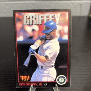 Seattle Mariners Ken Griffey Jr. Triple Play baseball trading card, powerful swinging action shot in protective sleeve, high quality vintage rare collectible in clear display case for serious baseball fans and investors today.