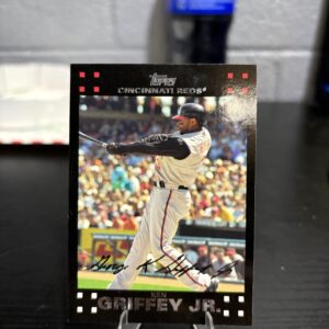 Cincinnati Reds Ken Griffey Jr. Topps baseball trading card, powerful swinging action shot in protective sleeve, high quality vintage rare collectible in clear display case for serious baseball fans and investors today.