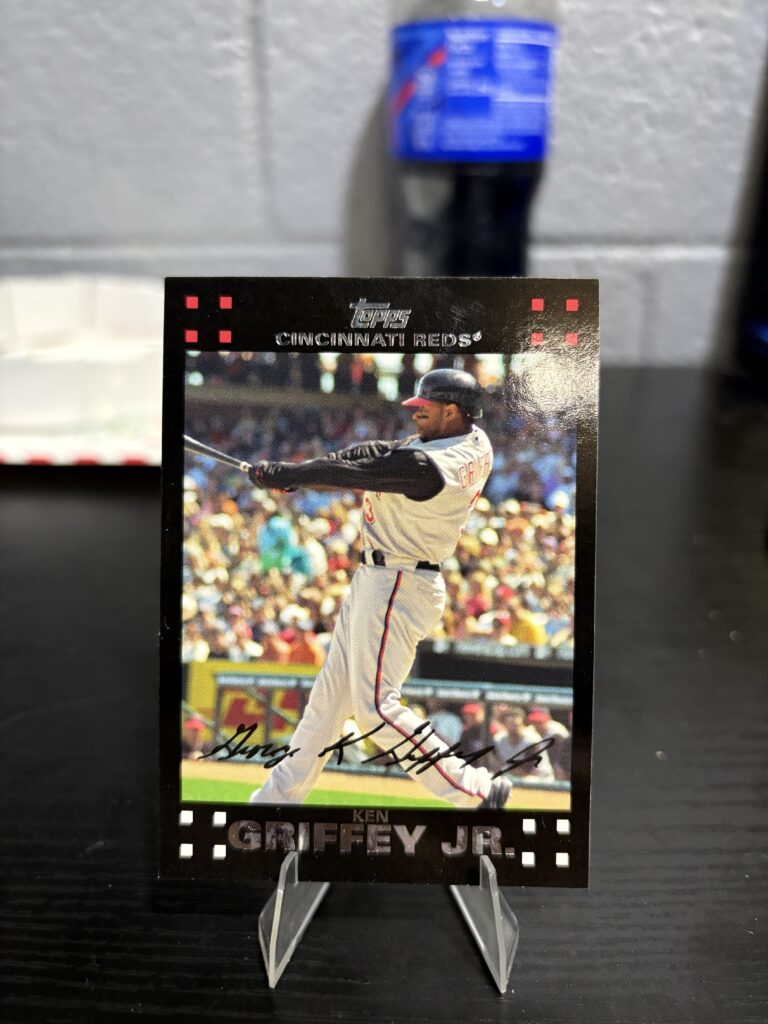 Cincinnati Reds Ken Griffey Jr. Topps baseball trading card, powerful swinging action shot in protective sleeve, high quality vintage rare collectible in clear display case for serious baseball fans and investors today.