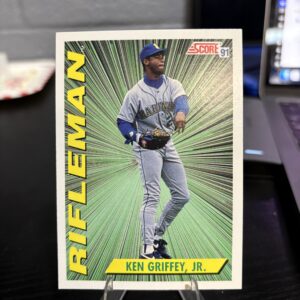 1991 Score Rifleman Ken Griffey Jr baseball card featuring the legendary Seattle Mariners outfielder in a vibrant green stylized design perfect for any sports trading card enthusiast.