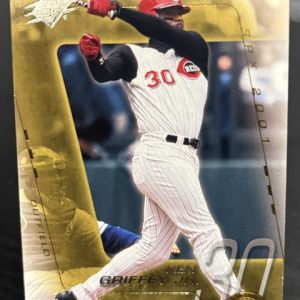 2001 SPx Ken Griffey Jr baseball card featuring the Cincinnati Reds legend in his batting stance with a gold foil aesthetic for dedicated collectors building wealth today.