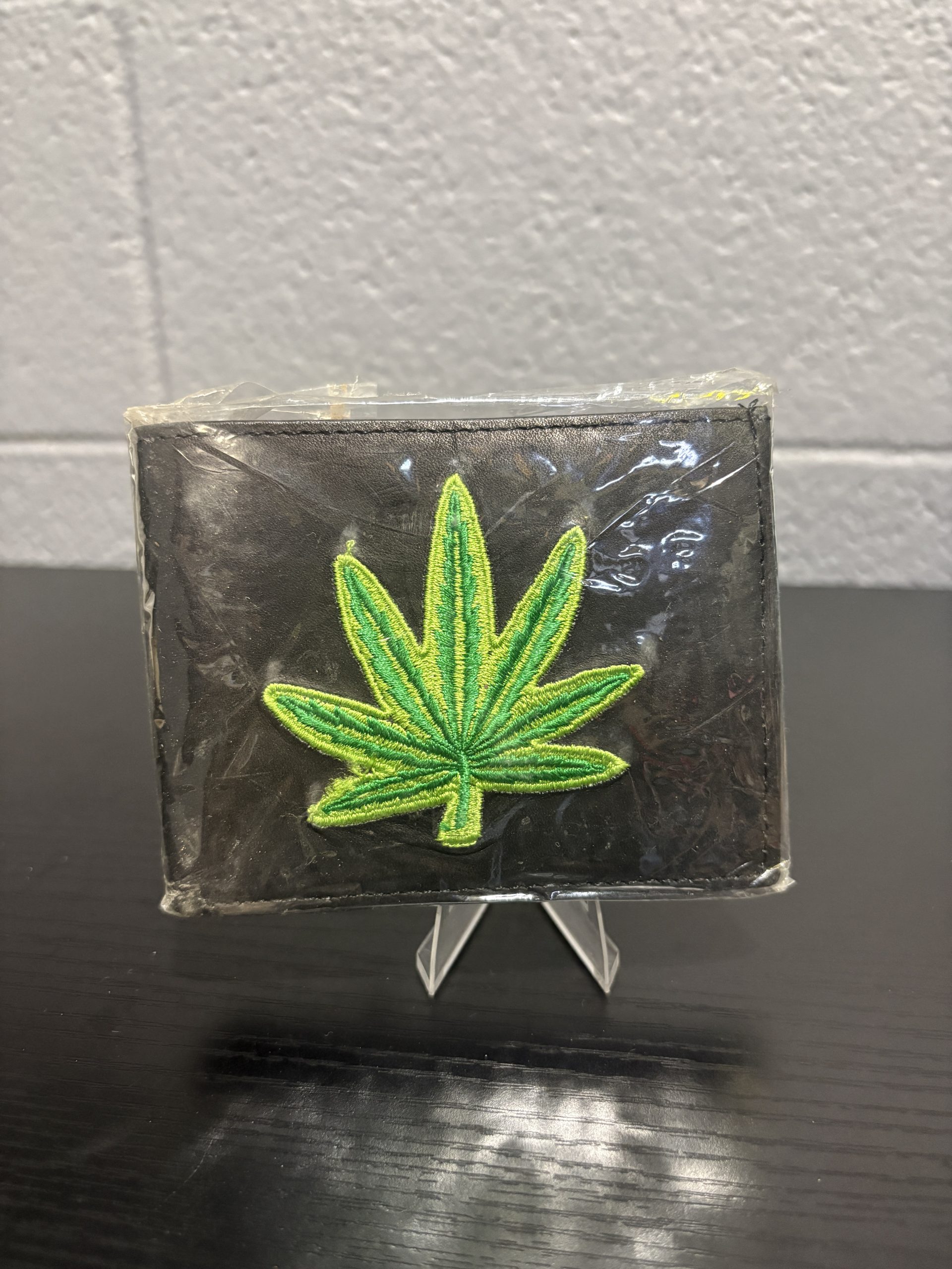Brand new black leather wallet featuring a vibrant embroidered green leaf design, a classic accessory for enthusiasts looking to add functional, high-value assets to their collection today.
