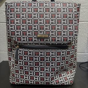 Stylish Tommy Hilfiger monogram backpack featuring the iconic brand pattern, a must-have designer accessory for those building a high-value, fashionable collection.