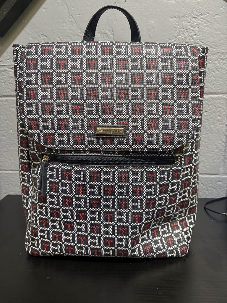 Stylish Tommy Hilfiger monogram backpack featuring the iconic brand pattern, a must-have designer accessory for those building a high-value, fashionable collection.