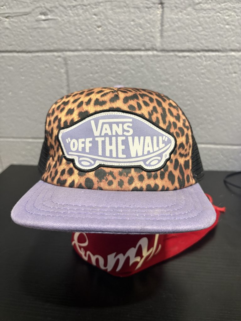 Unique Vans "Off The Wall" trucker cap featuring a bold leopard print and lilac purple accents, a stylish collectible accessory for those adding prosperity to their portfolio today.