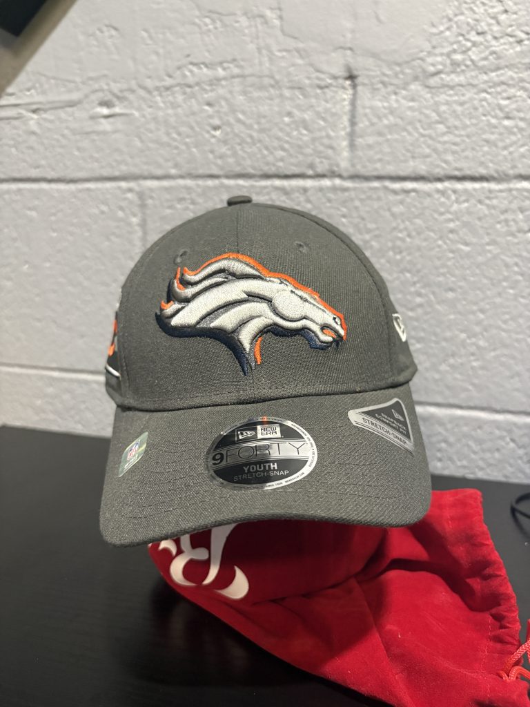 Youth Denver Broncos NFL New Era 9FORTY cap in charcoal grey, a stylish and professional accessory for sports fans looking to add high-value, authentic team gear to their collection today.