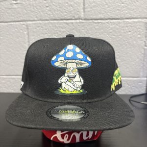 Black snapback cap featuring a vibrant, stylized mushroom character graphic, a bold and eccentric accessory for collectors looking to add high-energy, unique assets to their portfolio today.