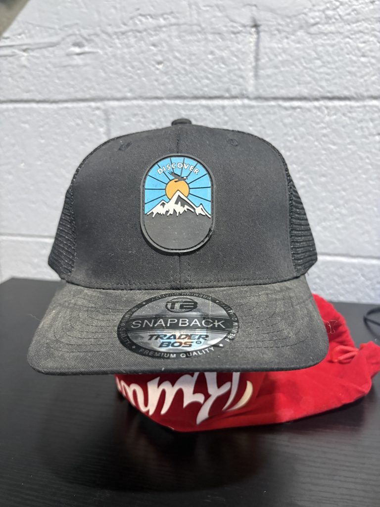 Black "Discover" mountain-themed Trader Bos snapback cap, a stylish and adventure-ready accessory for those building a high-value, unique collection today.