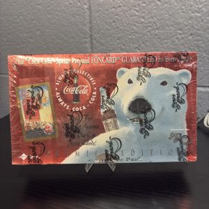 Factory-sealed 1990s Coca-Cola "Premier Edition" trading card box by The Score Board, featuring iconic polar bear art and guaranteed prepaid phone cards, a high-value asset for serious Coca-Cola collectors today.