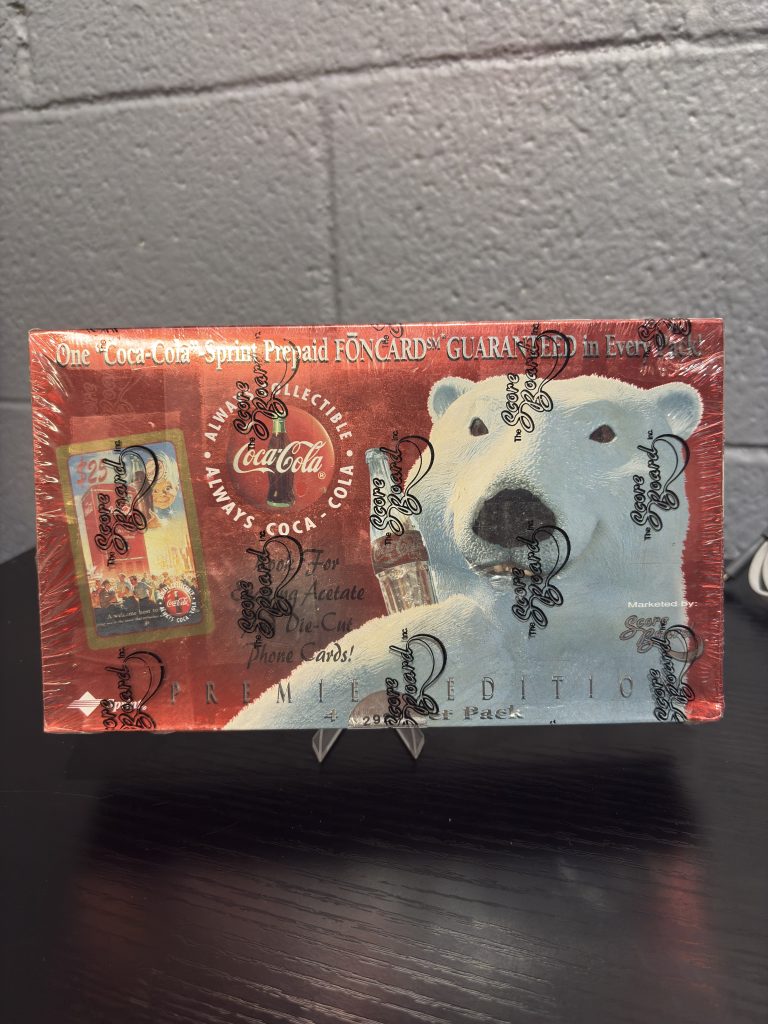 Factory-sealed 1990s Coca-Cola "Premier Edition" trading card box by The Score Board, featuring iconic polar bear art and guaranteed prepaid phone cards, a high-value asset for serious Coca-Cola collectors today.