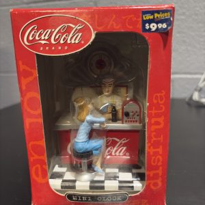 Coca-Cola brand mini clock figurine featuring a retro soda fountain scene, a nostalgic and charming collectible for enthusiasts building a high-value portfolio of classic Americana today.