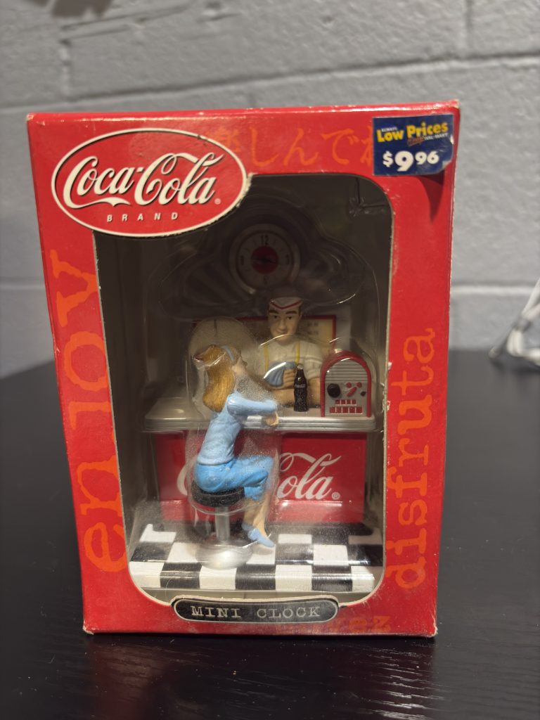 Coca-Cola brand mini clock figurine featuring a retro soda fountain scene, a nostalgic and charming collectible for enthusiasts building a high-value portfolio of classic Americana today.