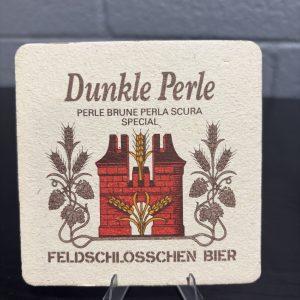 Set of 2 vintage Feldschlösschen Bier coasters, featuring branding for Dunkle Perle and a promotional image depicting a sophisticated dining scene, perfect for collectors looking to manifest prosperity and add authentic