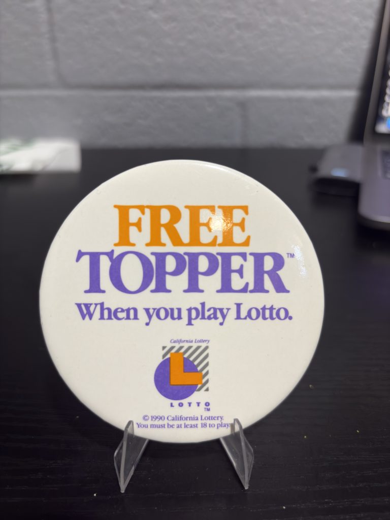 Vintage 1990 California Lottery "FREE TOPPER" promotional pinback button, a high-vibration collectible perfect for enthusiasts of gaming and state lottery memorabilia looking to manifest prosperity today