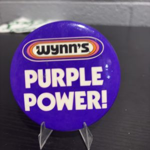 Vintage Wynn's "Purple Power!" promotional pinback button, a high-vibration collectible perfect for enthusiasts of automotive advertising memorabilia looking to manifest prosperity today.