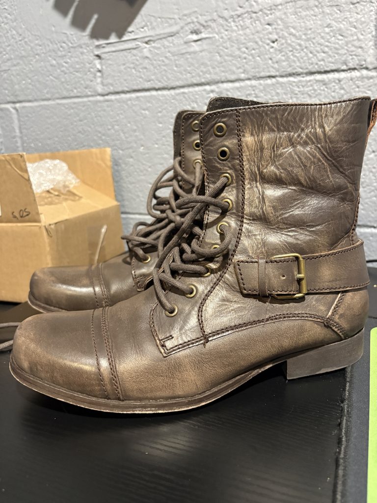 Pre-owned women's BX by Bronx distressed brown leather combat-style boots with lace-up design and decorative buckle, a stylish, high-vibration wardrobe essential perfect for manifesting confidence and prosperity.