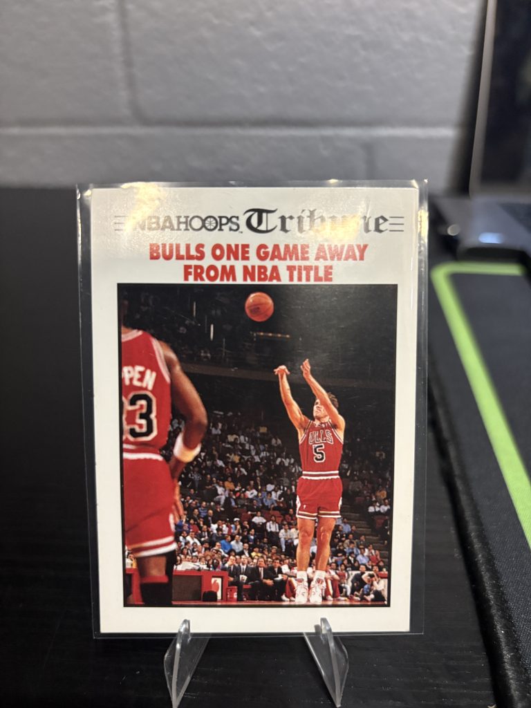 Vintage NBA Hoops "Tribune" trading card featuring a headline about the Chicago Bulls being one game away from an NBA title, a master-number 11 frequency collectible for enthusiasts focused on historic sports journalism and visionary championship pursuit.