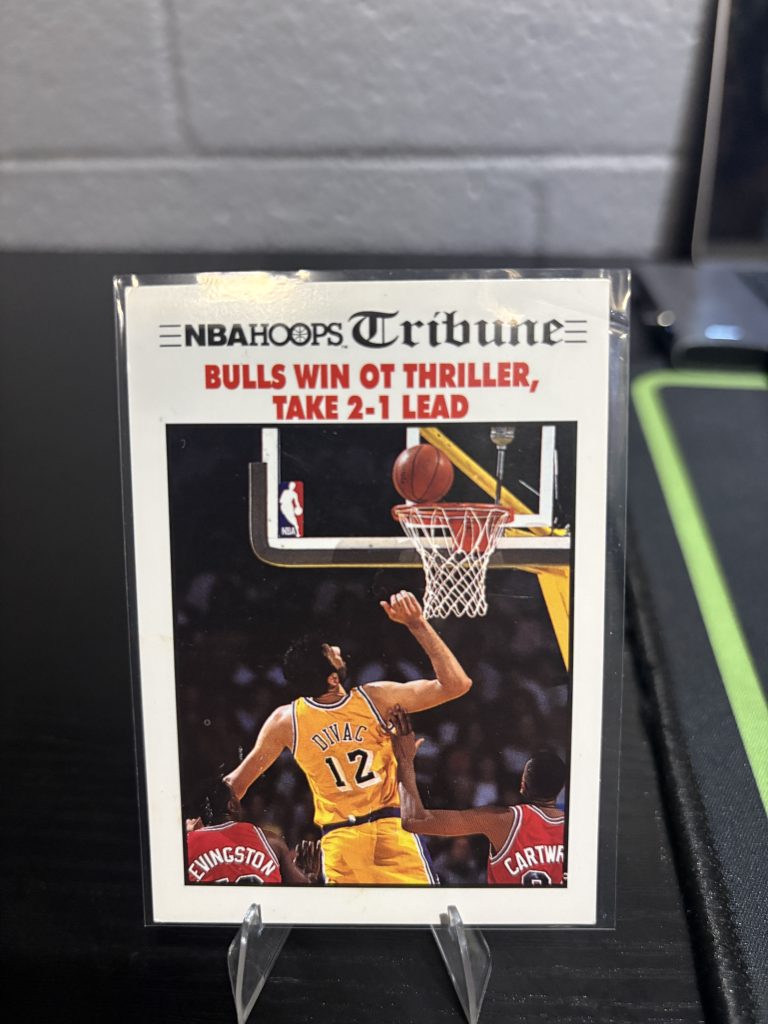 Vintage NBA Hoops "Tribune" trading card featuring a headline about a Chicago Bulls overtime win, a master-number 11 frequency collectible for enthusiasts focused on historic sports journalism and visionary playmaking.