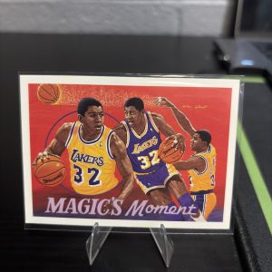 Vintage "Magic's Moment" trading card featuring artistic illustrations of Magic Johnson, a master-number 11 frequency collectible for basketball enthusiasts focused on historic excellence and visionary playmaking.