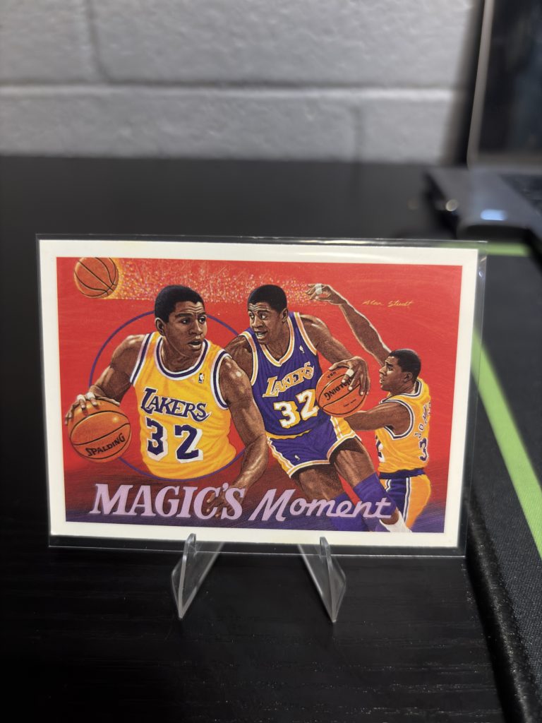 Vintage "Magic's Moment" trading card featuring artistic illustrations of Magic Johnson, a master-number 11 frequency collectible for basketball enthusiasts focused on historic excellence and visionary playmaking.