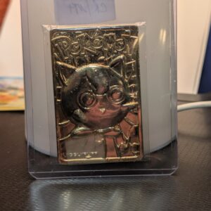 Vintage 1999 Burger King 23K gold-plated Jigglypuff Pokémon promotional trading card displayed in a clear protective case on a stand.