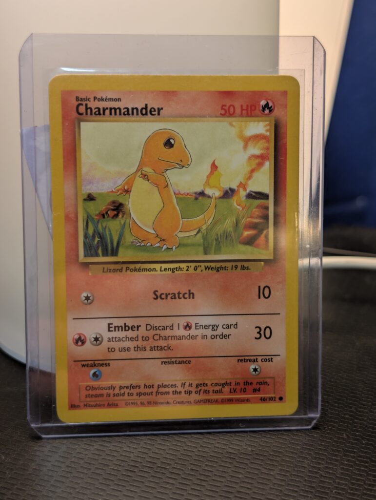 Vintage Unlimited Base Set Charmander Pokémon trading card number 46 out of 102, displayed inside a clear protective plastic toploader sleeve.