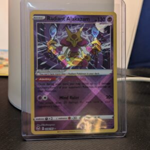 Radiant Alakazam holographic Pokémon trading card, number 059/195 from the Silver Tempest set, displayed in a clear protective plastic sleeve.