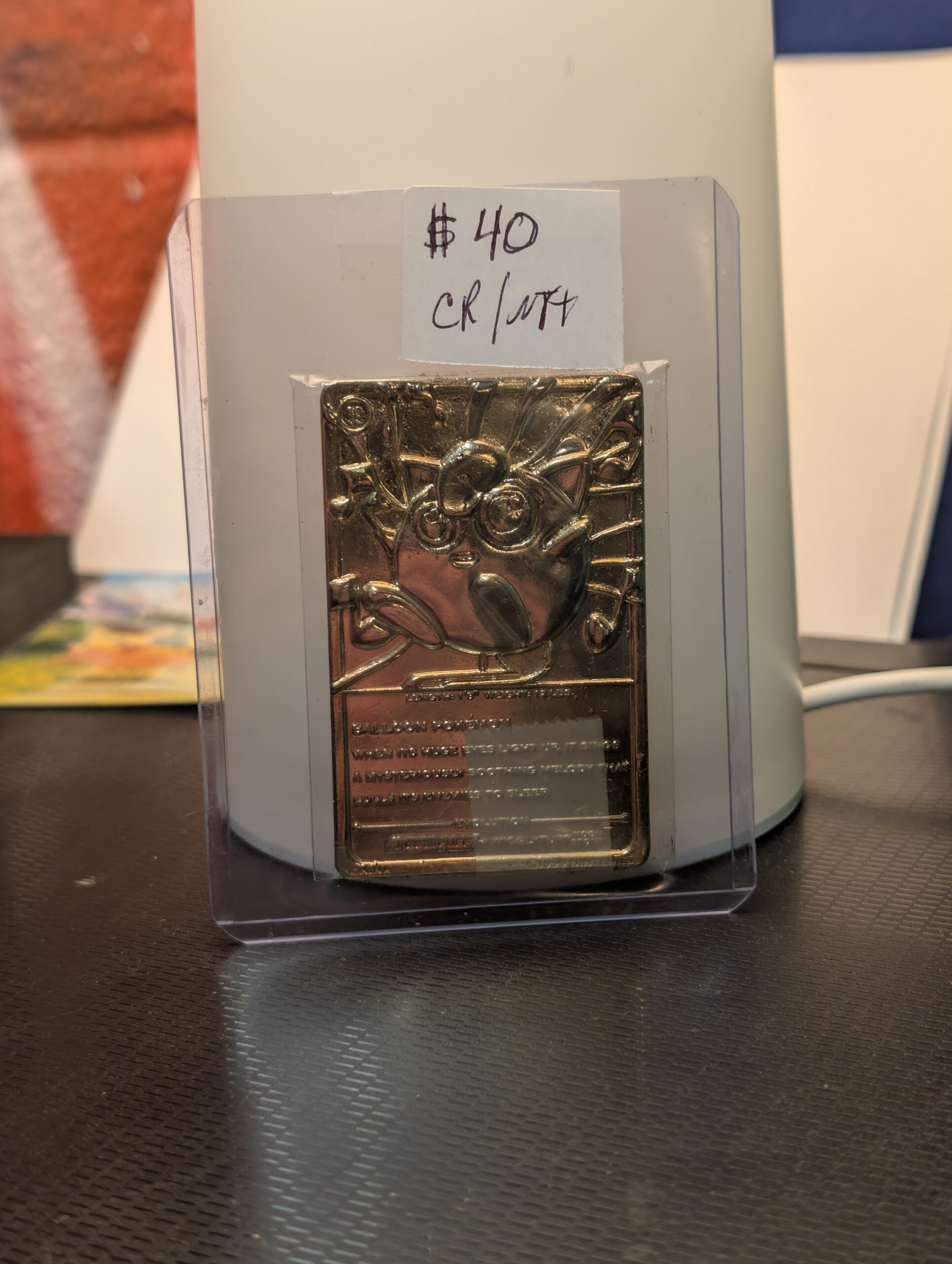 Back side of a vintage 1999 Burger King 23K gold-plated Jigglypuff Pokémon promotional trading card, displaying the stamped character statistics and Pokédex information.