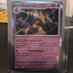 Holographic Alakazam Pokémon trading card, number 056/132 from the Mega Evolution expansion set, displayed in a clear protective plastic sleeve.