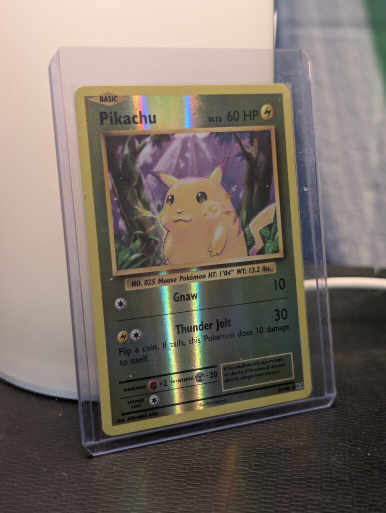 Reverse holographic Pikachu Pokémon trading card, number 35/108 from the 2016 XY Evolutions expansion set, displayed in a clear protective plastic sleeve.