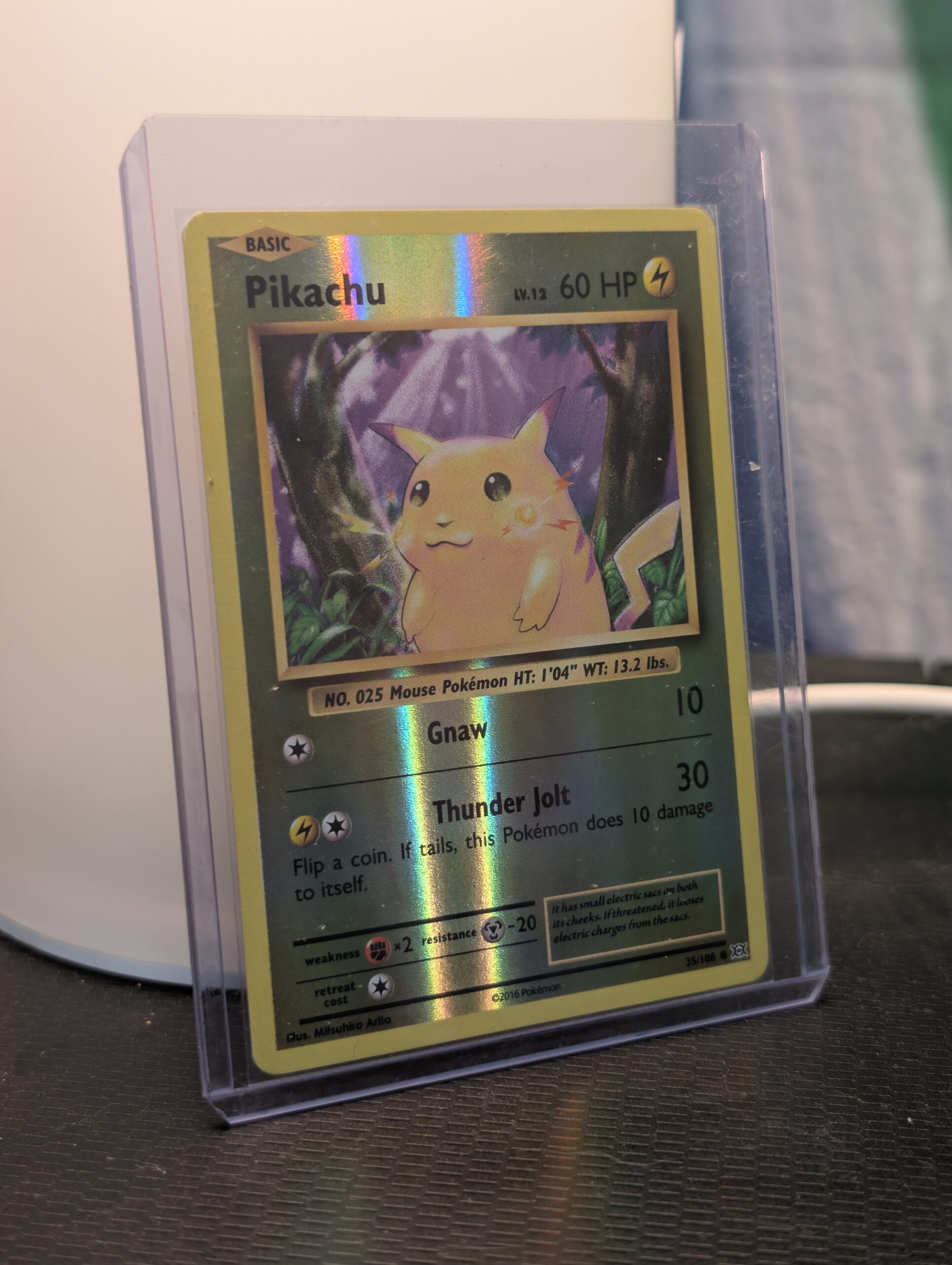 Reverse holographic Pikachu Pokémon trading card, number 35/108 from the 2016 XY Evolutions expansion set, displayed in a clear protective plastic sleeve.