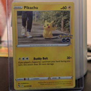 2022 Pokémon GO Pikachu trading card, number 027/078, featuring Pikachu walking on a sidewalk, displayed in a clear protective plastic sleeve.
