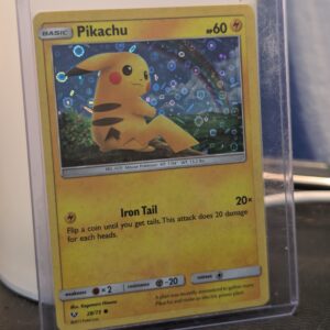 Holographic Pikachu Pokémon trading card, number 28/73 from the 2017 Shining Legends expansion, featuring the General Mills sequin holofoil pattern, displayed in a clear protective plastic sleeve.