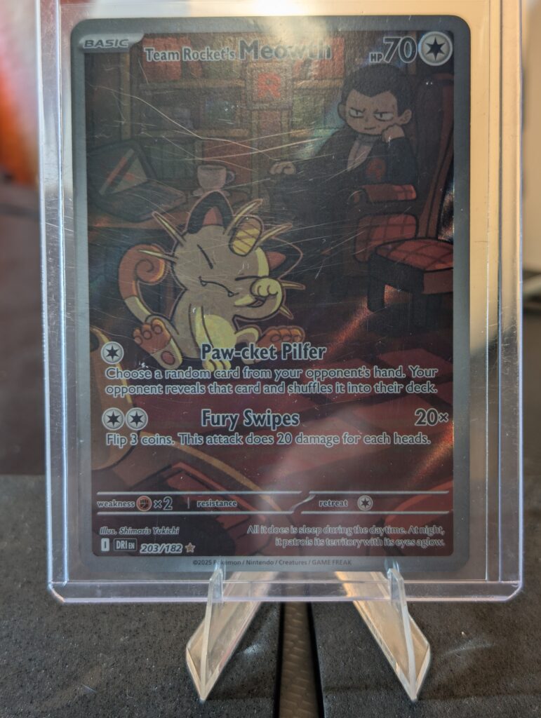 Stunning authentic Team Rocket Meowth illustration rare holographic modern trading card from Destined Rivals expansion safely displayed inside clear protective plastic sleeve for premium retail collection upgrades today.