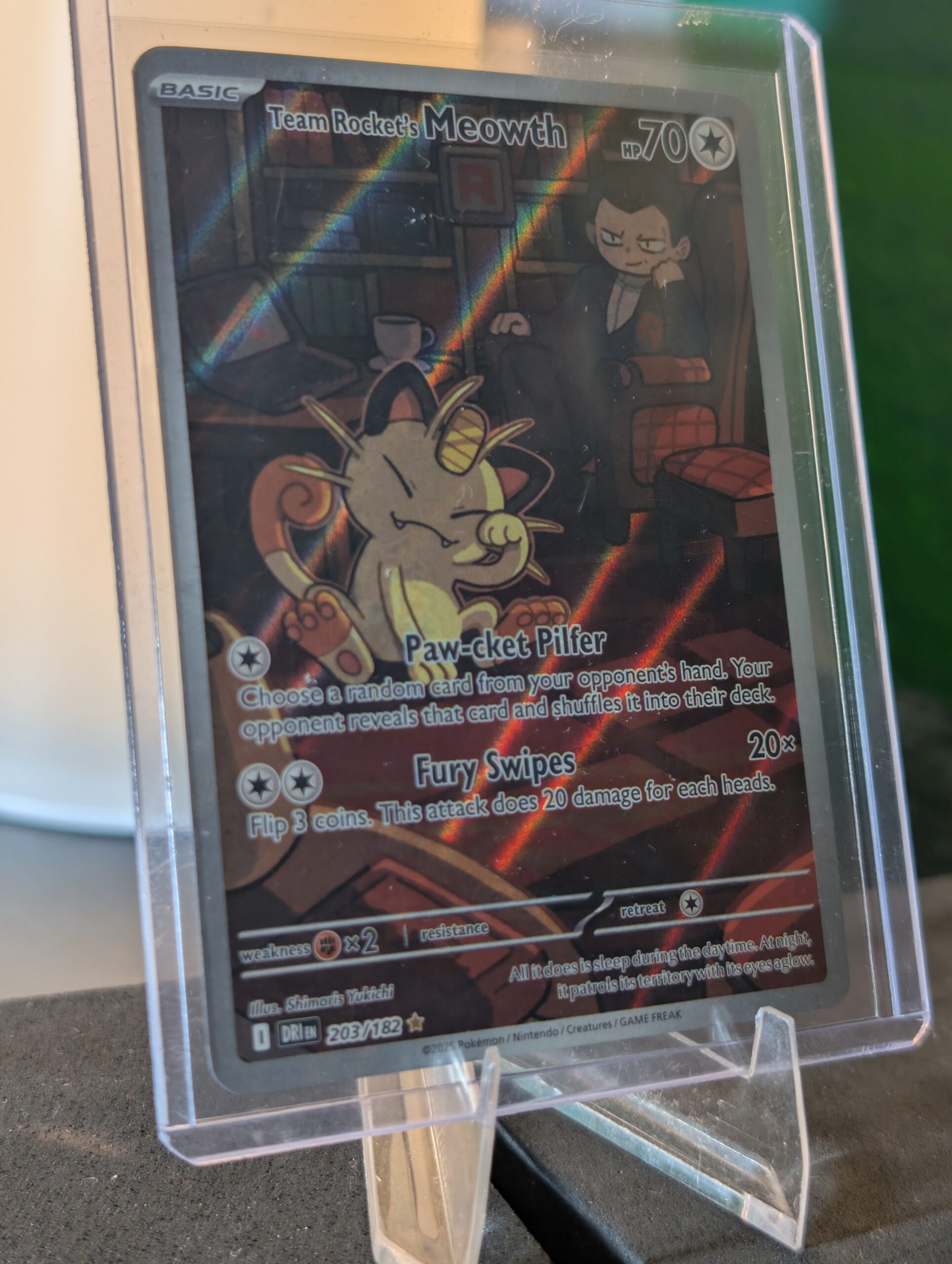 Stunning authentic Team Rocket Meowth illustration rare holographic modern trading card from Destined Rivals expansion safely displayed inside clear protective plastic sleeve for premium retail collection upgrades today.