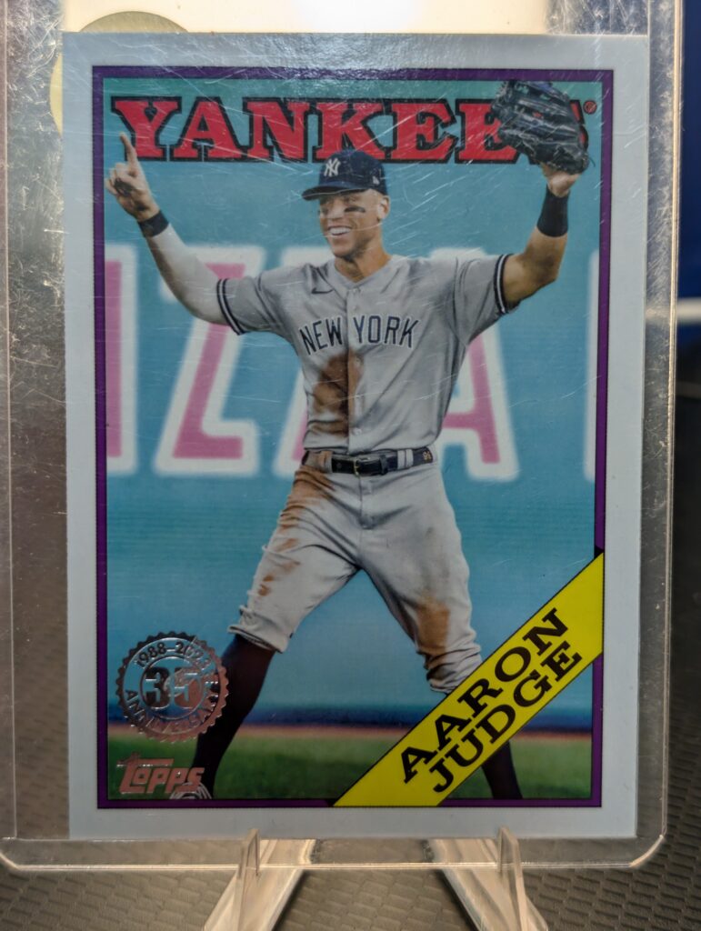 Authentic 2023 Topps Aaron Judge vintage baseball trading card displaying the classic 1988 35th anniversary design safely protected inside a clear plastic sleeve for premium collectors.