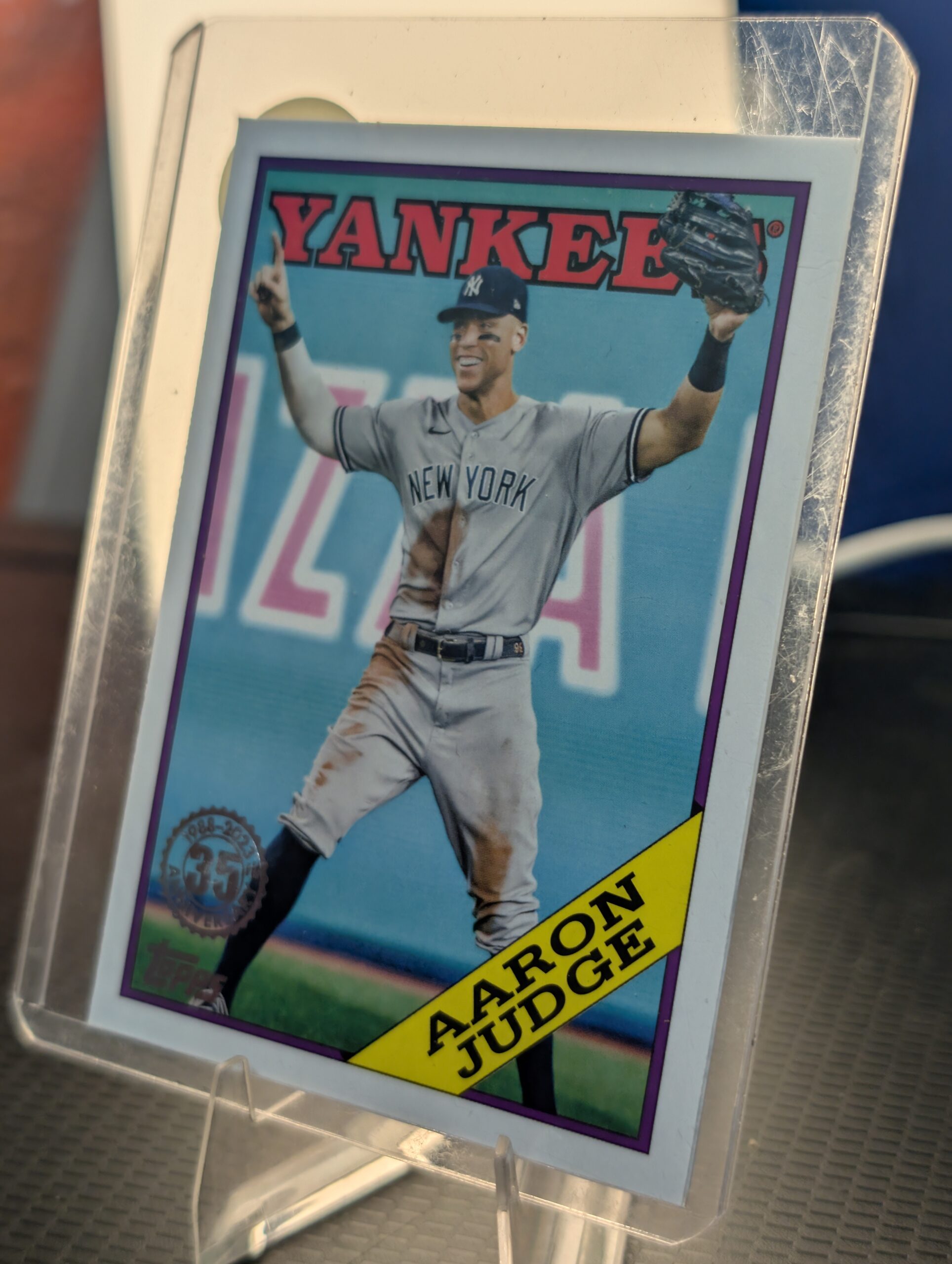 Authentic 2023 Topps Aaron Judge vintage baseball trading card displaying the classic 1988 35th anniversary design safely protected inside a clear plastic sleeve for premium collectors.