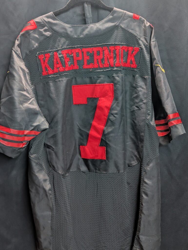Authentic used black Nike San Francisco forty niners Colin Kaepernick football jersey in size forty eight displaying classic red stitched numbers perfectly captured for premium sports apparel collectors.